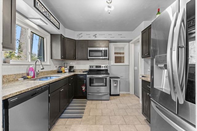 1111 N Franklin St, Dearborn, MI 48128 - kitchen featuring stainless steel appliances, light stone counters, a sink, and tasteful backsplash