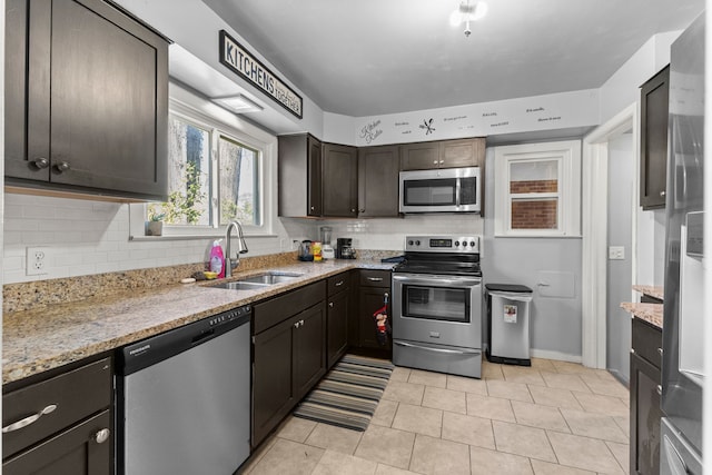 1111 N Franklin St, Dearborn, MI 48128 - kitchen featuring stainless steel appliances, light stone countertops, a sink, and tasteful backsplash
