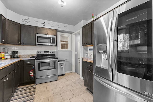 1111 N Franklin St, Dearborn, MI 48128 - kitchen with light tile patterned floors, appliances with stainless steel finishes, light stone countertops, and backsplash