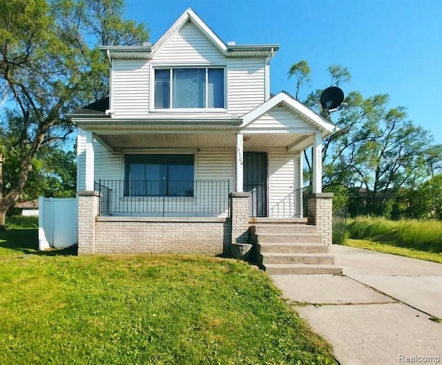 bungalow-style house with covered porch and a front lawn