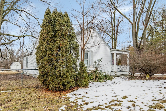 view of snowy exterior with fence