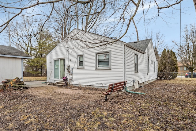 view of front of property with roof with shingles, fence, and entry steps