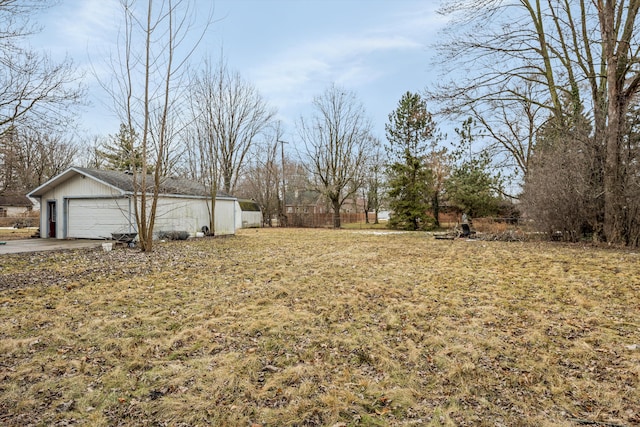 view of yard with fence and a garage