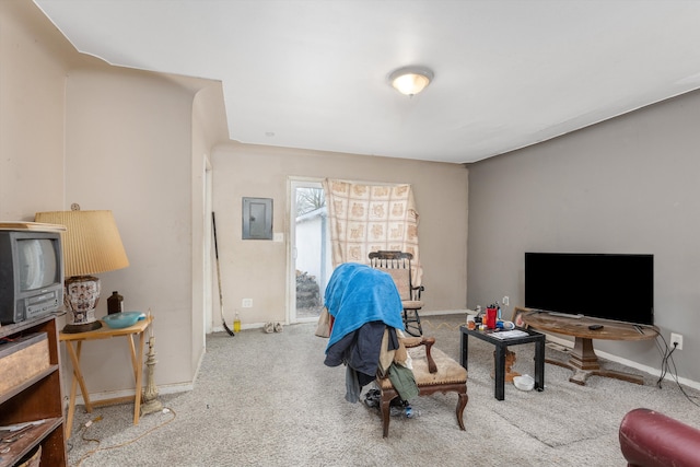 carpeted living area featuring baseboards and electric panel