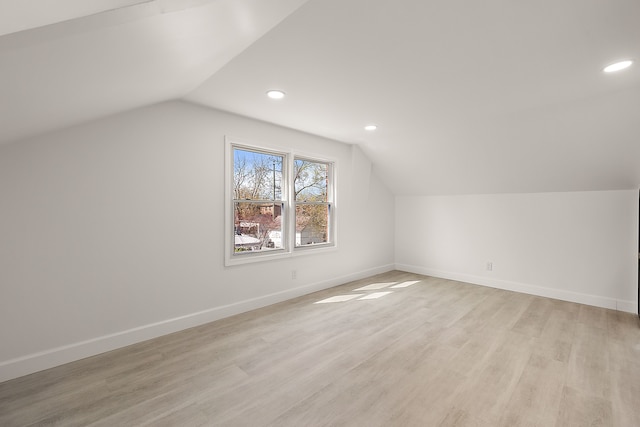 bonus room with recessed lighting, baseboards, light wood finished floors, and lofted ceiling