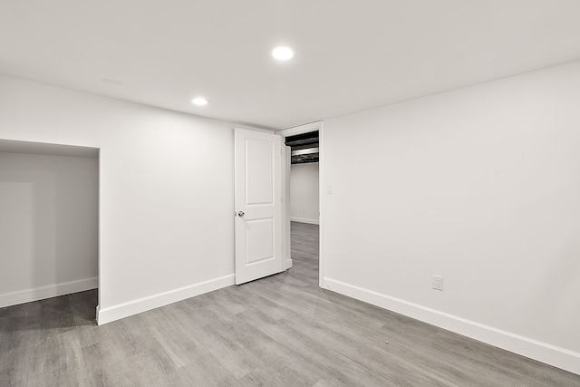 finished basement with recessed lighting, baseboards, and wood finished floors