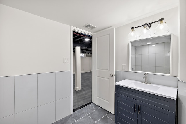 full bathroom featuring vanity, tile patterned flooring, walk in shower, and visible vents