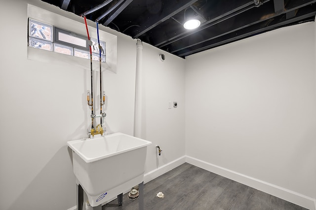 below grade area featuring baseboards and dark wood-style flooring
