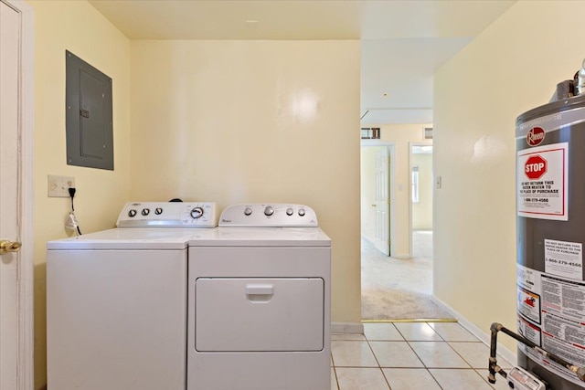 laundry area featuring electric panel, independent washer and dryer, light tile patterned floors, baseboards, and water heater