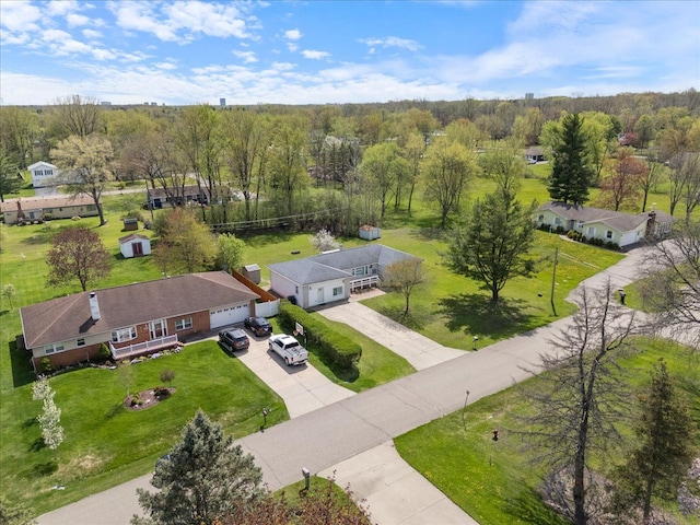 birds eye view of property featuring a view of trees
