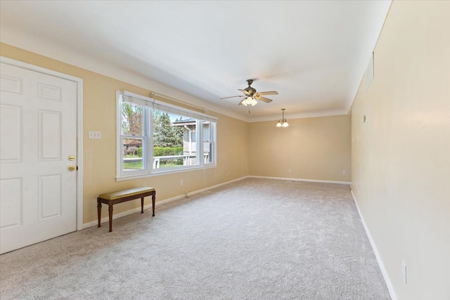 spare room featuring carpet floors, baseboards, and a ceiling fan