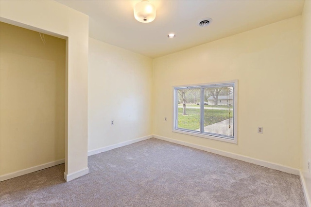 empty room featuring baseboards and carpet