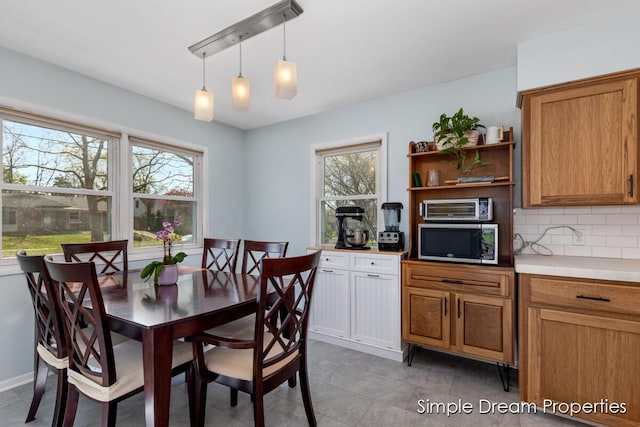 dining space with a toaster, light tile patterned floors, and plenty of natural light