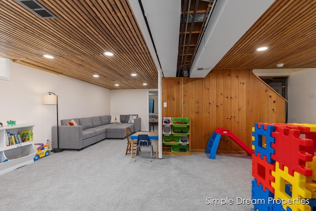 rec room featuring carpet floors, wood walls, recessed lighting, and visible vents