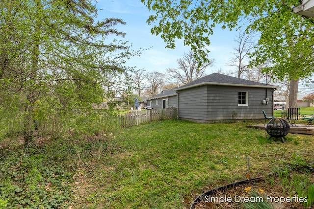 view of yard featuring fence and an outdoor fire pit