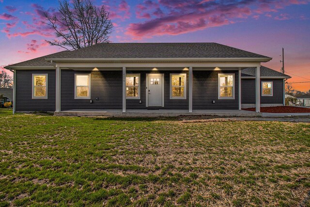 back of house featuring a yard and a porch