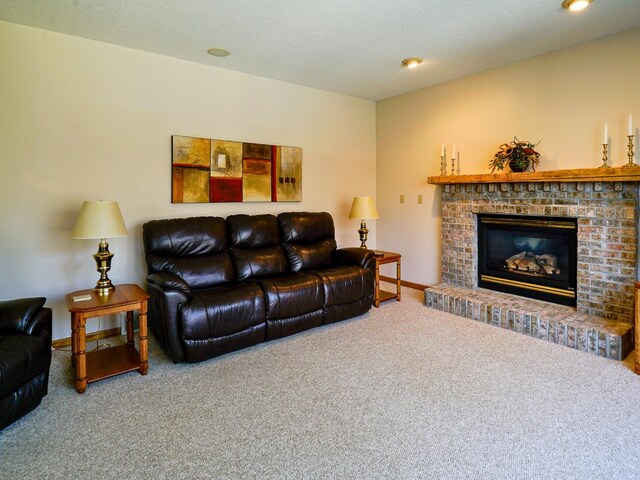 carpeted living room with baseboards, a fireplace, and a textured ceiling