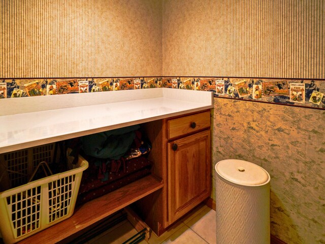 bathroom featuring wallpapered walls and tile patterned floors