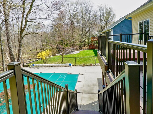 exterior space with fence and a covered pool