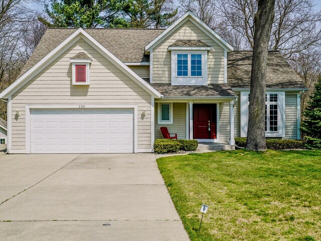 view of front of home featuring a garage, covered porch, a front yard, roof with shingles, and driveway