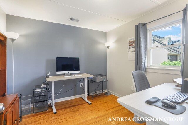 office with baseboards, light wood finished floors, and visible vents