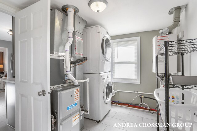 laundry room with laundry area, stacked washer and dryer, and light tile patterned flooring