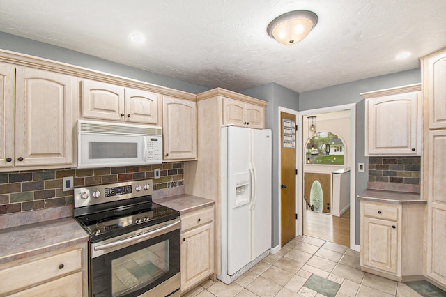 4741 Pin Oak Trl, Jackson, MI 49201 - kitchen featuring light brown cabinetry, white appliances, light countertops, light tile patterned floors, and backsplash