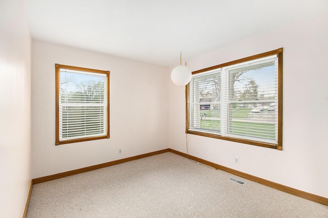 4741 Pin Oak Trl, Jackson, MI 49201 - spare room featuring baseboards, light colored carpet, and visible vents