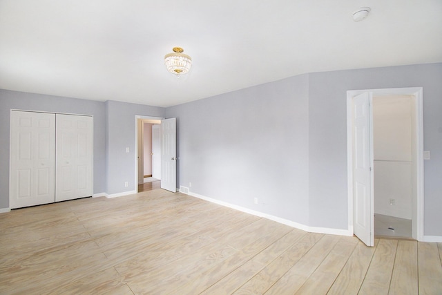 4741 Pin Oak Trl, Jackson, MI 49201 - unfurnished bedroom featuring baseboards, light wood-style flooring, and a closet