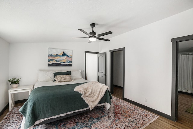 bedroom with baseboards, ceiling fan, and wood finished floors