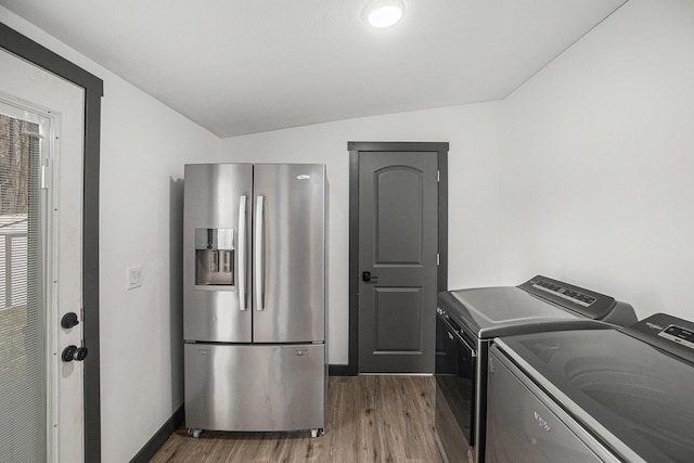 washroom with baseboards, laundry area, independent washer and dryer, and wood finished floors
