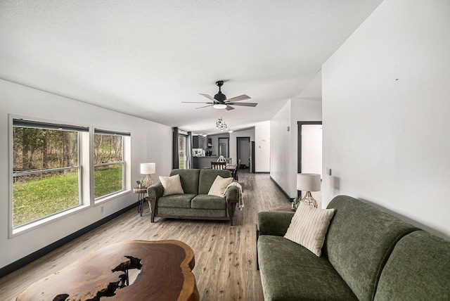 1499 N Apple Dr, White Cloud, MI 49349 - living area featuring baseboards, light wood finished floors, and ceiling fan