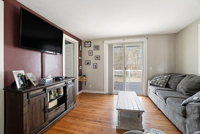 living area with baseboards and light wood-style flooring