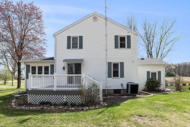 back of property featuring a wooden deck, central AC unit, and a lawn