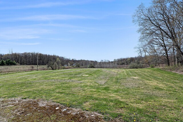 exterior space featuring a rural view and a forest view