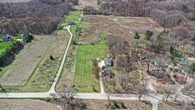 drone / aerial view with a view of trees and a rural view