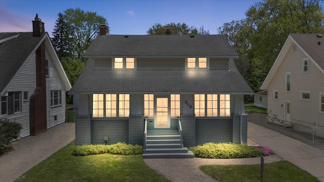 view of front facade with a shingled roof