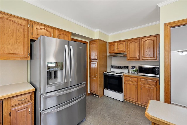 kitchen with brown cabinets, appliances with stainless steel finishes, tile patterned floors, under cabinet range hood, and ornamental molding