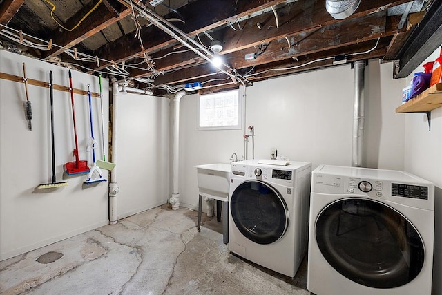 laundry room with laundry area, a sink, and washing machine and clothes dryer