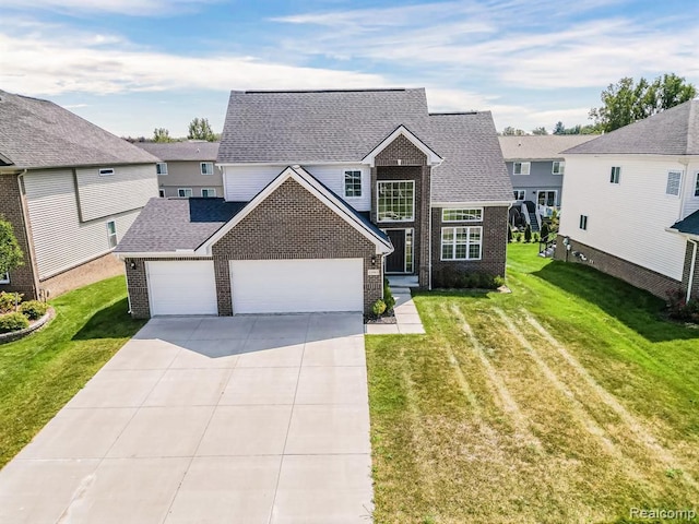 traditional-style home featuring brick siding, a garage, a front yard, and concrete driveway