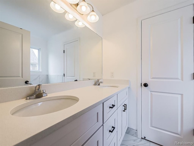 bathroom featuring a sink, double vanity, and marble finish floor