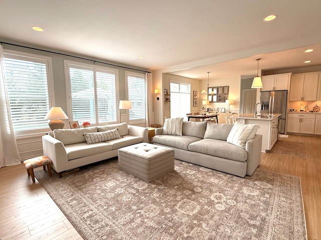 living area with recessed lighting and light wood-type flooring