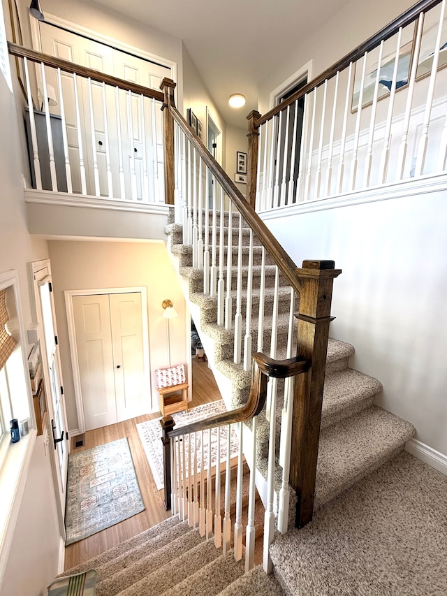 stairway with baseboards and wood finished floors