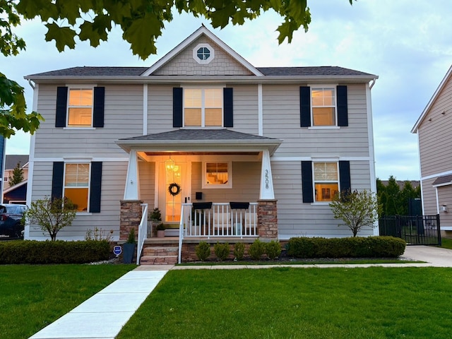 view of front of house with covered porch and a front yard