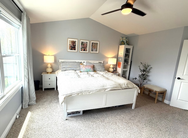 bedroom with ceiling fan, vaulted ceiling, and light carpet