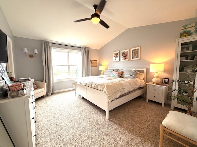 bedroom featuring ceiling fan, light colored carpet, baseboards, and lofted ceiling
