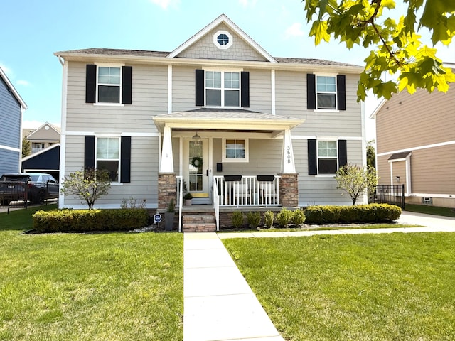view of front of property with covered porch and a front lawn