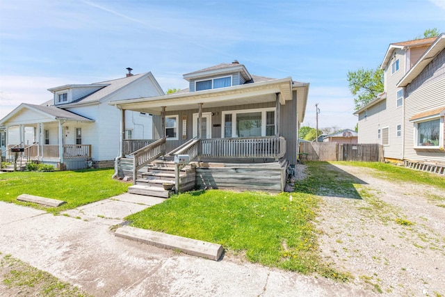 934 Smith St, Monroe, MI 48161 - bungalow-style home featuring a porch, fence, and a front yard