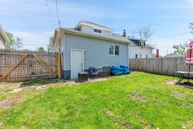 934 Smith St, Monroe, MI 48161 - back of property featuring a lawn, a fenced backyard, and central AC