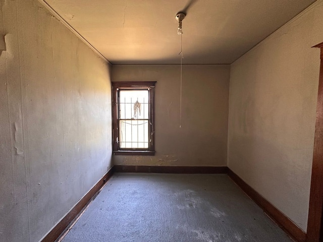unfurnished room featuring baseboards